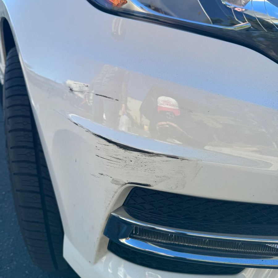 Scratched and scuffed front bumper before repair and refinishing